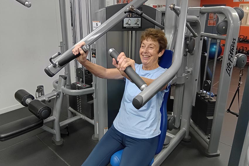A person exercising in the Never2old programme, using an exercise machine at the AUT gym