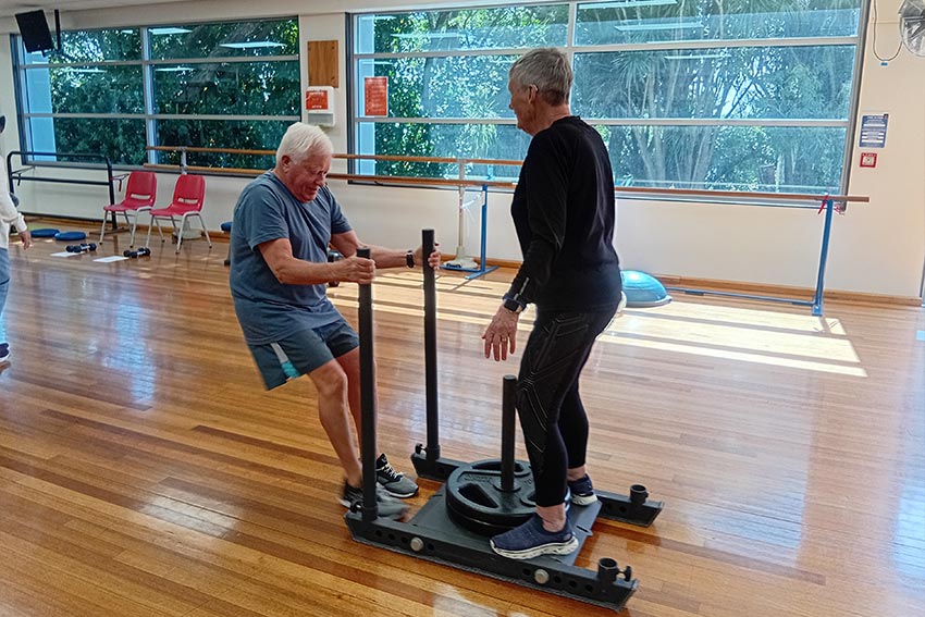A person exercising in the Never2old programme, using an exercise machine at the AUT gym